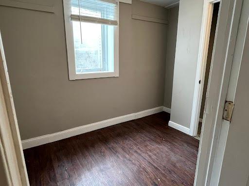 1541 Charles Ave, Saint Paul, MN 55104 - unfurnished bedroom featuring baseboards and dark wood-style floors