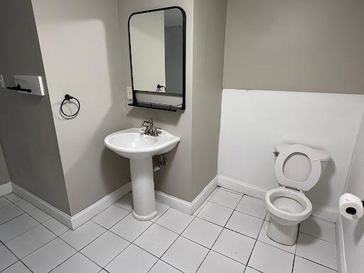 1541 Charles Ave, Saint Paul, MN 55104 - bathroom with toilet, baseboards, and tile patterned flooring