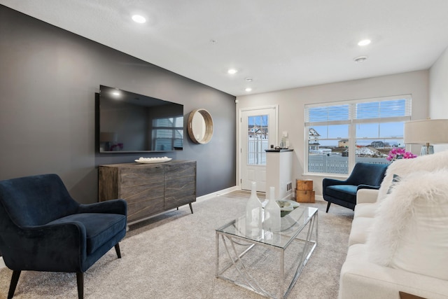 carpeted living area with recessed lighting and baseboards