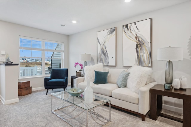 carpeted living area featuring recessed lighting and baseboards