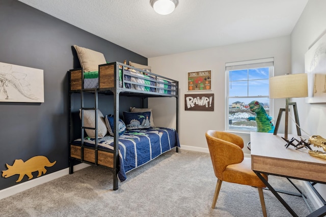 bedroom featuring carpet, baseboards, and a textured ceiling