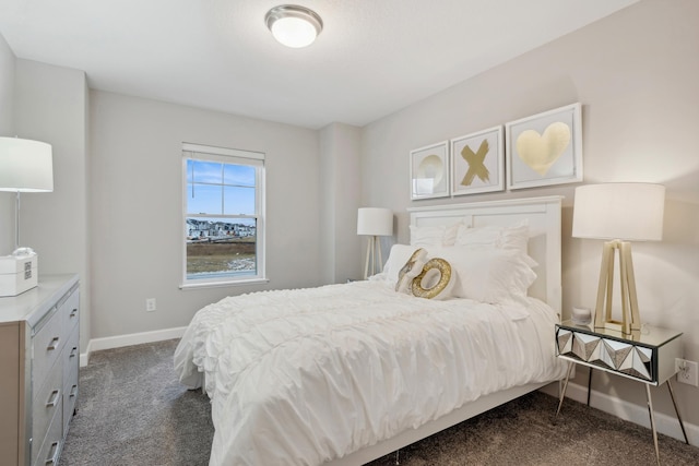bedroom featuring dark colored carpet and baseboards