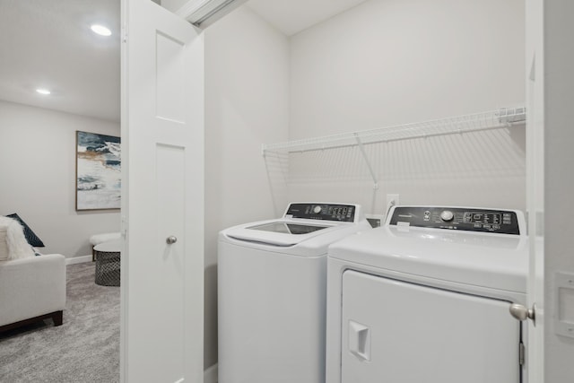 laundry room with washing machine and clothes dryer, carpet flooring, baseboards, and recessed lighting