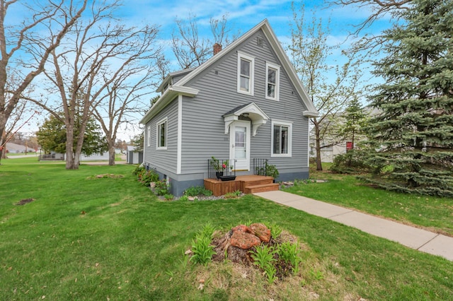 110 7th St SE, Little Falls, MN 56345 - view of front of home featuring a chimney and a front yard