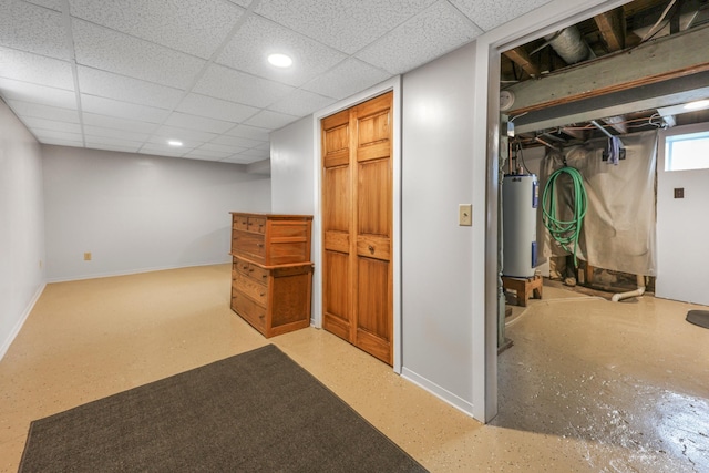 110 7th St SE, Little Falls, MN 56345 - below grade area featuring baseboards, water heater, a paneled ceiling, and recessed lighting
