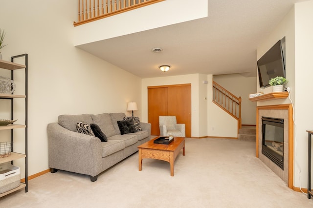 9277 Inland Ln N, Maple Grove, MN 55311 - carpeted living room with stairs, baseboards, and a tile fireplace