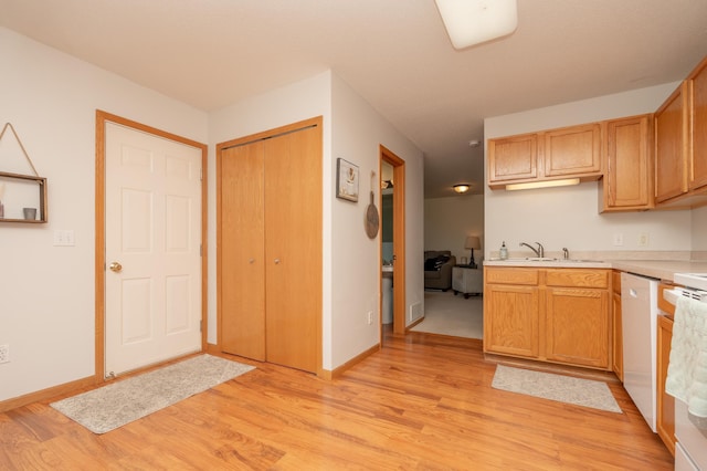 9277 Inland Ln N, Maple Grove, MN 55311 - kitchen with light countertops, light wood-style floors, a sink, and baseboards