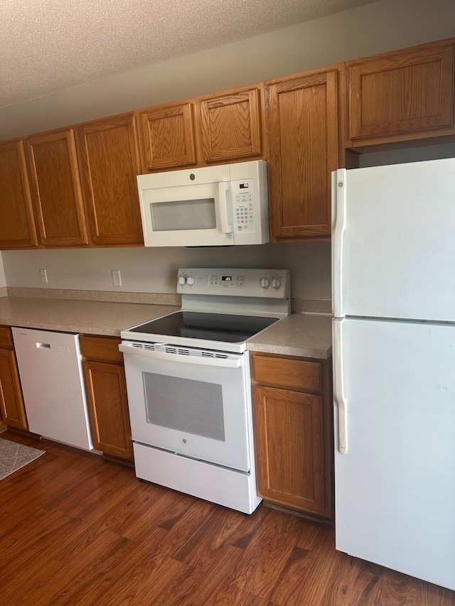 9277 Inland Ln N, Maple Grove, MN 55311 - kitchen with white appliances, brown cabinets, dark wood-style floors, and light countertops