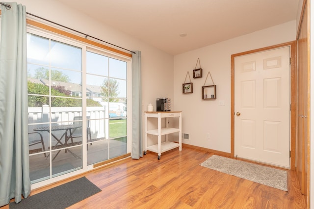 9277 Inland Ln N, Maple Grove, MN 55311 - doorway with light wood-style floors and baseboards