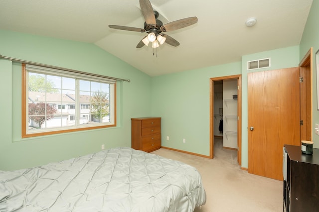9277 Inland Ln N, Maple Grove, MN 55311 - bedroom featuring light carpet, vaulted ceiling, a walk in closet, baseboards, and a closet