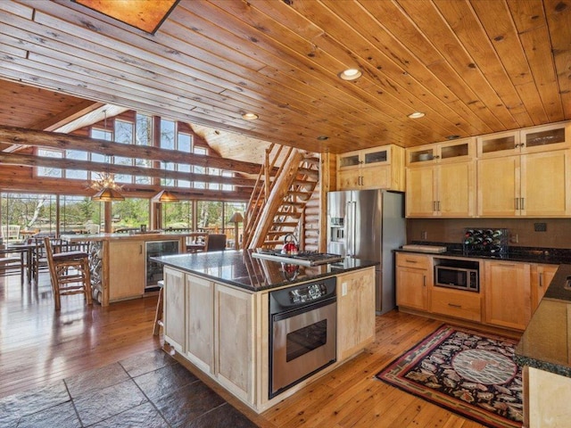 15464 Birch Narrows Rd, Crosslake, MN 56472 - kitchen with appliances with stainless steel finishes, beverage cooler, wood ceiling, a kitchen island, and glass insert cabinets