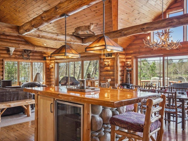 15464 Birch Narrows Rd, Crosslake, MN 56472 - kitchen with rustic walls, hardwood / wood-style floors, beamed ceiling, wood ceiling, and open floor plan