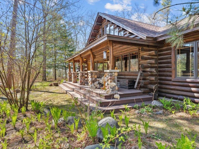 15464 Birch Narrows Rd, Crosslake, MN 56472 - view of property exterior with log exterior, roof with shingles, and a deck