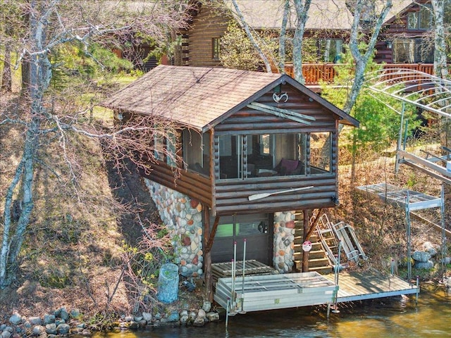 15464 Birch Narrows Rd, Crosslake, MN 56472 - view of outdoor structure with stairway, a water view, and a sunroom
