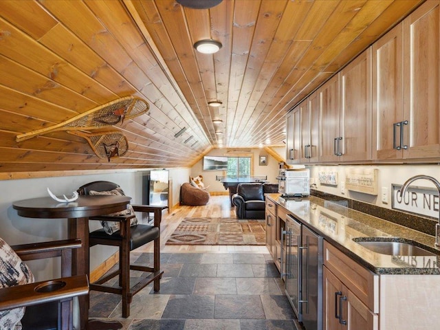 15464 Birch Narrows Rd, Crosslake, MN 56472 - kitchen with a sink, wooden ceiling, vaulted ceiling, dark stone counters, and dark stone finish floors