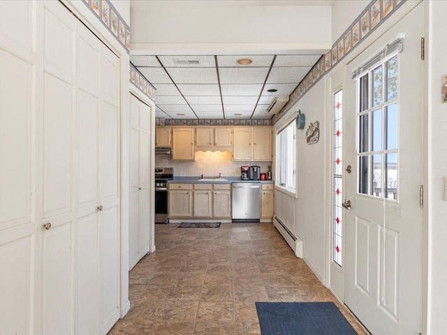 kitchen featuring stainless steel appliances, baseboard heating, a paneled ceiling, tasteful backsplash, and light brown cabinets