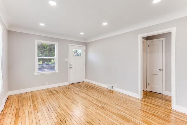 entryway with wood-type flooring, baseboards, and recessed lighting