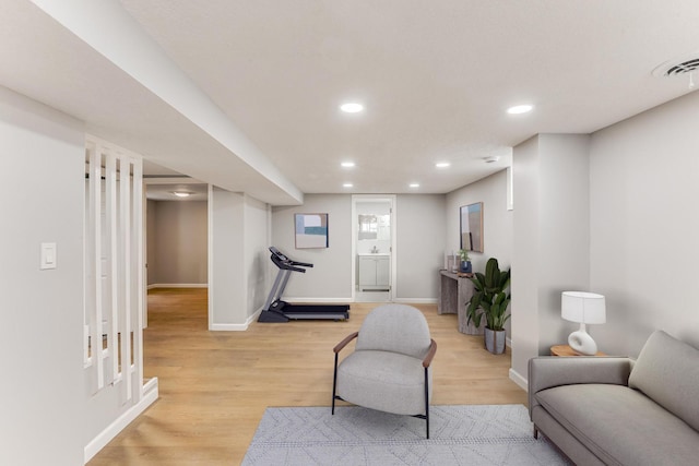 sitting room featuring light wood-style flooring, baseboards, and recessed lighting