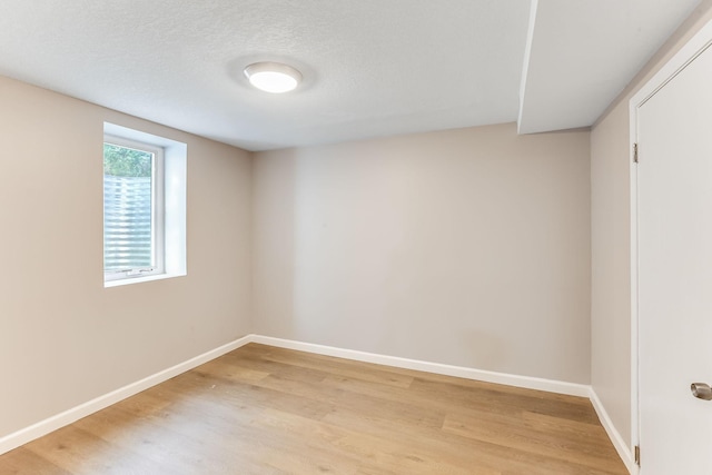 spare room with light wood finished floors and baseboards