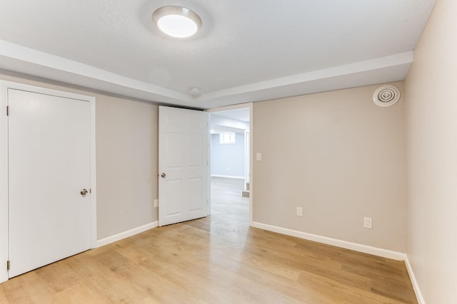 unfurnished bedroom with light wood-type flooring and baseboards