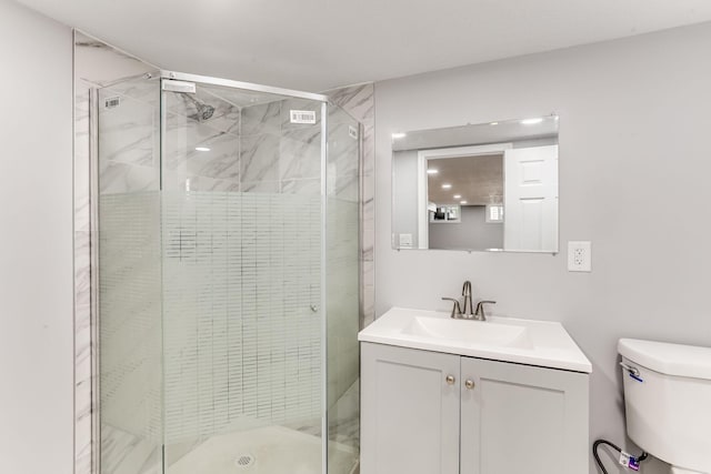 full bathroom with a shower stall, toilet, and vanity