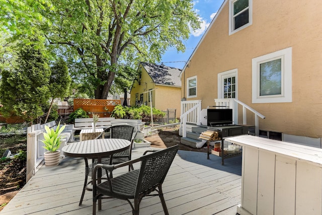 deck with fence and outdoor dining area