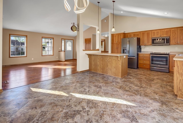 809 3rd Ave SE, Cold Spring, MN 56320 - kitchen with appliances with stainless steel finishes, light countertops, pendant lighting, a peninsula, and high vaulted ceiling