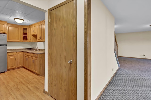 809 3rd Ave SE, Cold Spring, MN 56320 - kitchen featuring a sink, freestanding refrigerator, light carpet, and baseboards