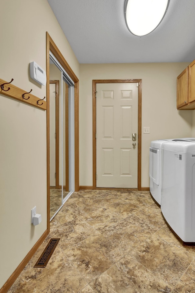 809 3rd Ave SE, Cold Spring, MN 56320 - laundry room with cabinet space, washing machine and clothes dryer, stone finish flooring, and baseboards