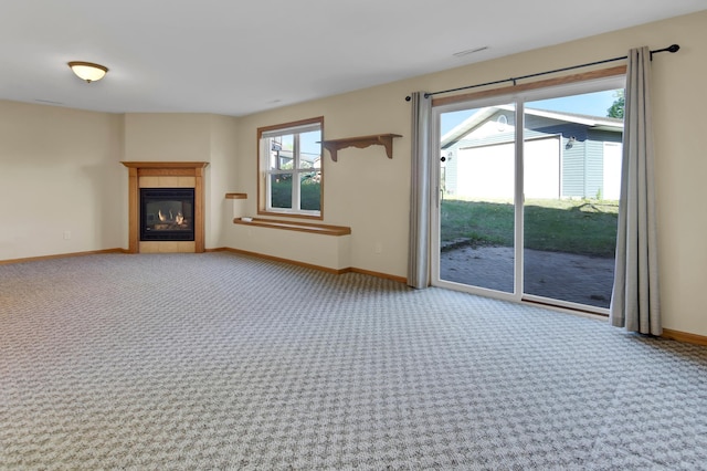 809 3rd Ave SE, Cold Spring, MN 56320 - unfurnished living room featuring light colored carpet, baseboards, and a tile fireplace