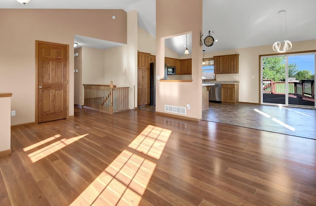 809 3rd Ave SE, Cold Spring, MN 56320 - unfurnished living room with wood finished floors, high vaulted ceiling, and baseboards