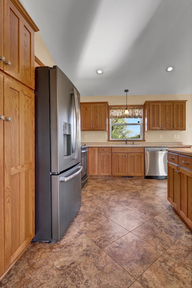 809 3rd Ave SE, Cold Spring, MN 56320 - kitchen with appliances with stainless steel finishes, a sink, decorative light fixtures, light countertops, and brown cabinetry
