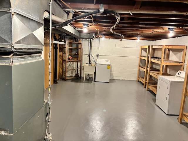 5028-5030 Nicollet Ave S, Minneapolis, MN 55419 - unfinished below grade area featuring separate washer and dryer, heating unit, concrete block wall, and a sink
