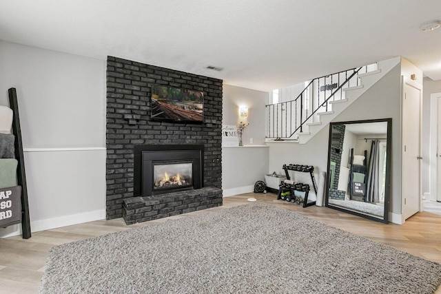 2313 122nd St, Burnsville, MN 55337 - living area featuring wood finished floors, a fireplace, and baseboards