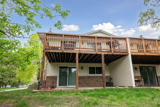2313 122nd St, Burnsville, MN 55337 - rear view of property featuring brick siding, a wooden deck, and a lawn
