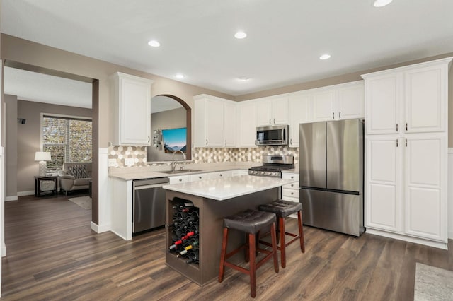4323 Victor Path Unit 1, Hugo, MN 55038 - kitchen with stainless steel appliances, a sink, a center island, tasteful backsplash, and white cabinetry