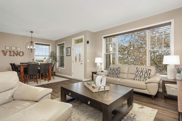 4323 Victor Path Unit 1, Hugo, MN 55038 - living room featuring a chandelier, dark wood-type flooring, and baseboards