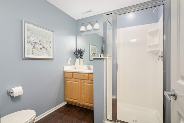 4323 Victor Path Unit 1, Hugo, MN 55038 - full bathroom featuring a shower stall, vanity, wood finished floors, toilet, and baseboards