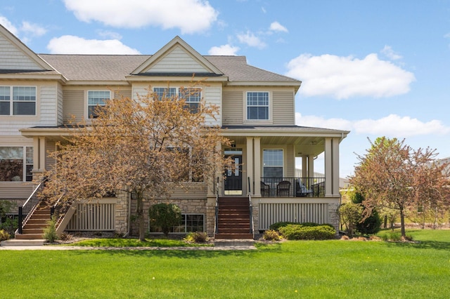 4323 Victor Path Unit 1, Hugo, MN 55038 - view of front facade with stairs, a porch, a front yard, stone siding, and a shingled roof