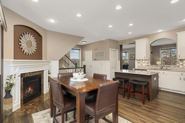 4323 Victor Path Unit 1, Hugo, MN 55038 - dining area featuring a high end fireplace, dark wood-style flooring, recessed lighting, stairway, and a wainscoted wall