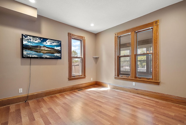 2911 California St NE, Minneapolis, MN 55418 - spare room featuring wood finished floors, baseboards, and recessed lighting