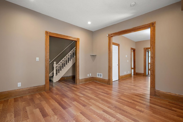 2911 California St NE, Minneapolis, MN 55418 - empty room featuring light wood-style flooring, baseboards, stairway, and recessed lighting