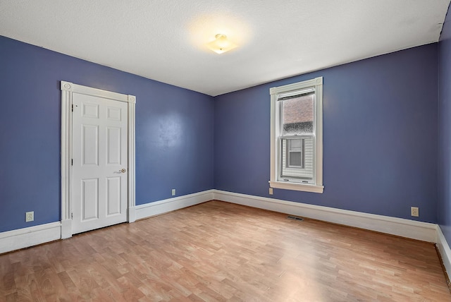 2911 California St NE, Minneapolis, MN 55418 - spare room with wood finished floors and baseboards