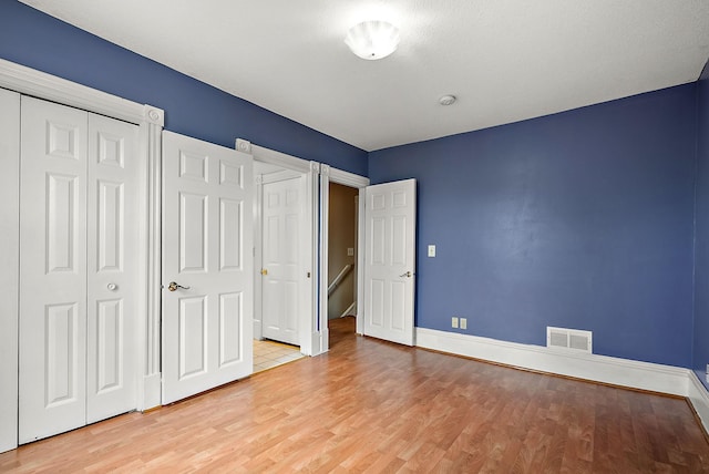 2911 California St NE, Minneapolis, MN 55418 - unfurnished bedroom featuring baseboards, wood finished floors, and a closet