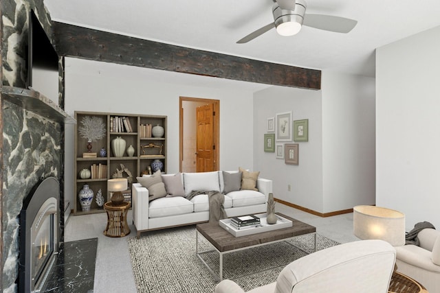 1031 Pheasant Trl, Hudson, WI 54016 - living room featuring a glass covered fireplace, ceiling fan, and baseboards
