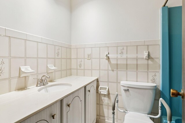 1031 Pheasant Trl, Hudson, WI 54016 - bathroom with toilet, vanity, and tile walls
