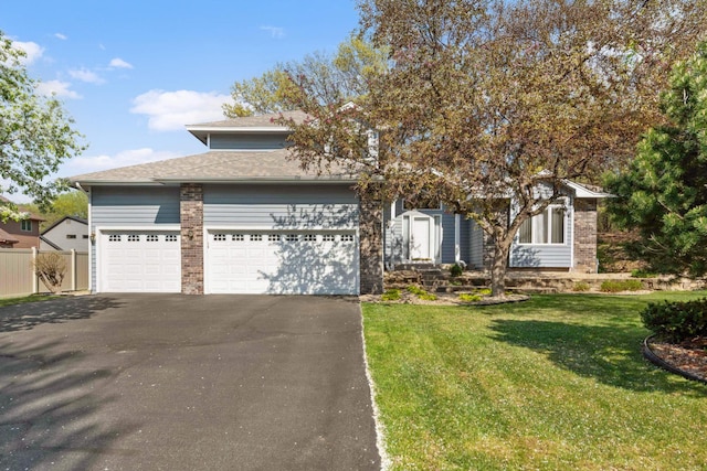 12625 Tiffany Ct, Burnsville, MN 55337 - view of front facade with asphalt driveway, an attached garage, and roof with shingles