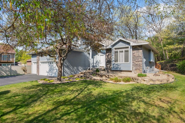 12625 Tiffany Ct, Burnsville, MN 55337 - view of front facade with brick siding, asphalt driveway, and an attached garage