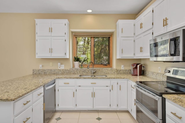 12625 Tiffany Ct, Burnsville, MN 55337 - kitchen featuring appliances with stainless steel finishes, a sink, white cabinets, light stone countertops, and light tile patterned flooring