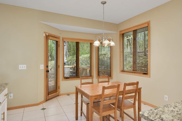 12625 Tiffany Ct, Burnsville, MN 55337 - dining area with a chandelier, healthy amount of natural light, baseboards, and light tile patterned floors